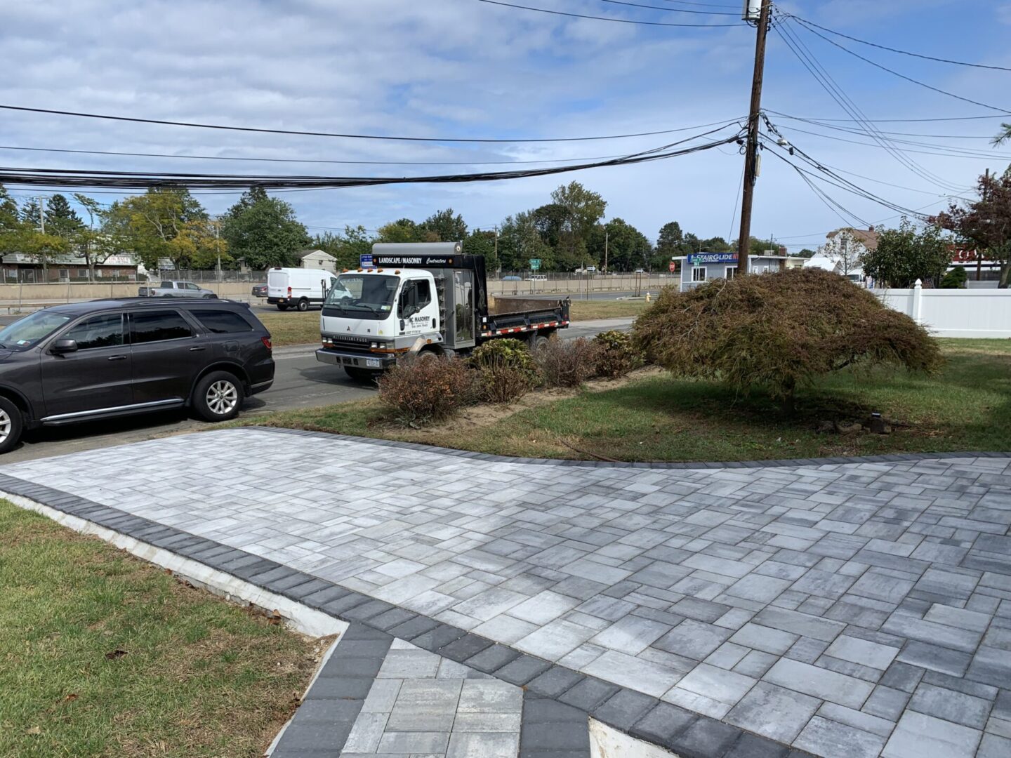 A freshly made front driveway of a house with concrete and tiles